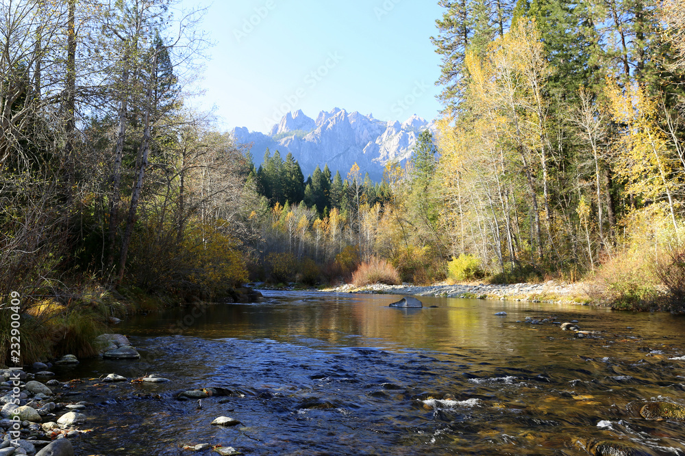 river in the forest in autumn with mountain in the background river in the forest in autumn with mountain in the background