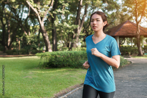 Exercise and healthy concept, Young asian runner woman running in the park in sportswear morning time, selective focus