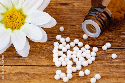 Homeopathy medicine with blossom of a flower
