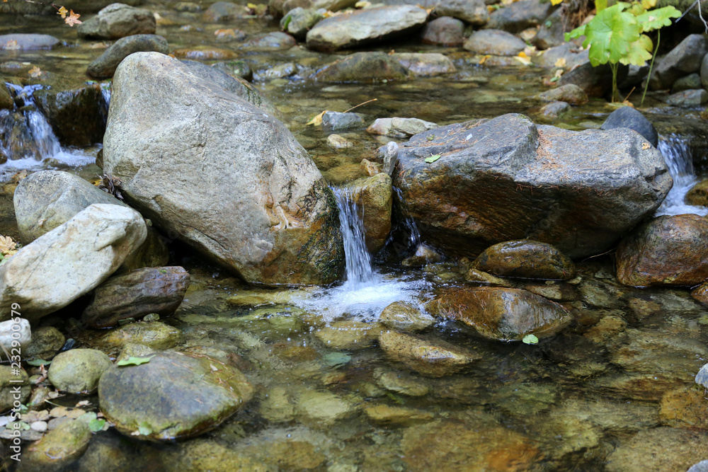 babbling brook with stones and small waterfall babbling brook with stones and small waterfall