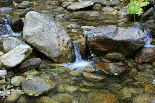babbling brook with stones and small waterfall