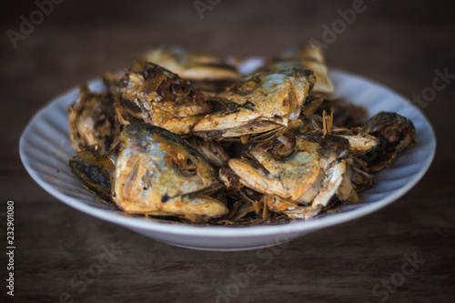 Fried fish heads for a simple meal of rural people in Thailand photo