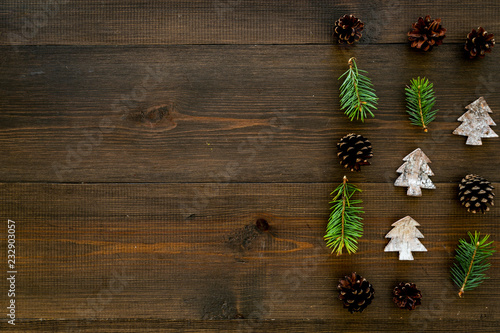 Winter ornament, New Year pattern. Pine sprigs, cones, spruce figure, fir oil on dark wooden background top view space for text