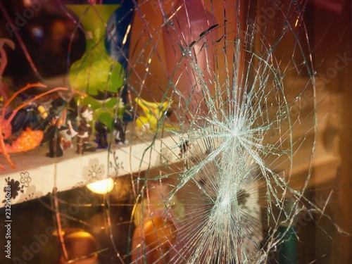 Broken shop window with color background