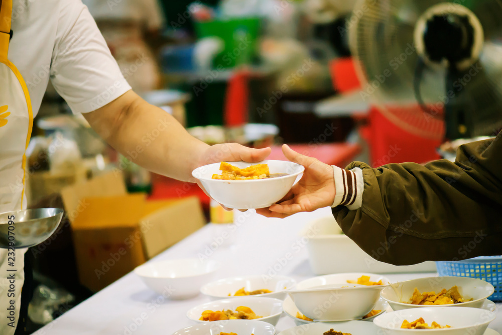 The hands of the rich give food to the hands of the poor. Concept: The concept of sharing The hands of the rich give food to the hands of the poor. Concept: The concept of sharing
