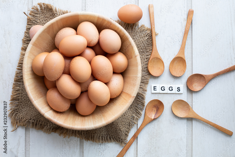 kitchen table with raw eggs set on wood basket. kitchen table with raw eggs set on wood basket.