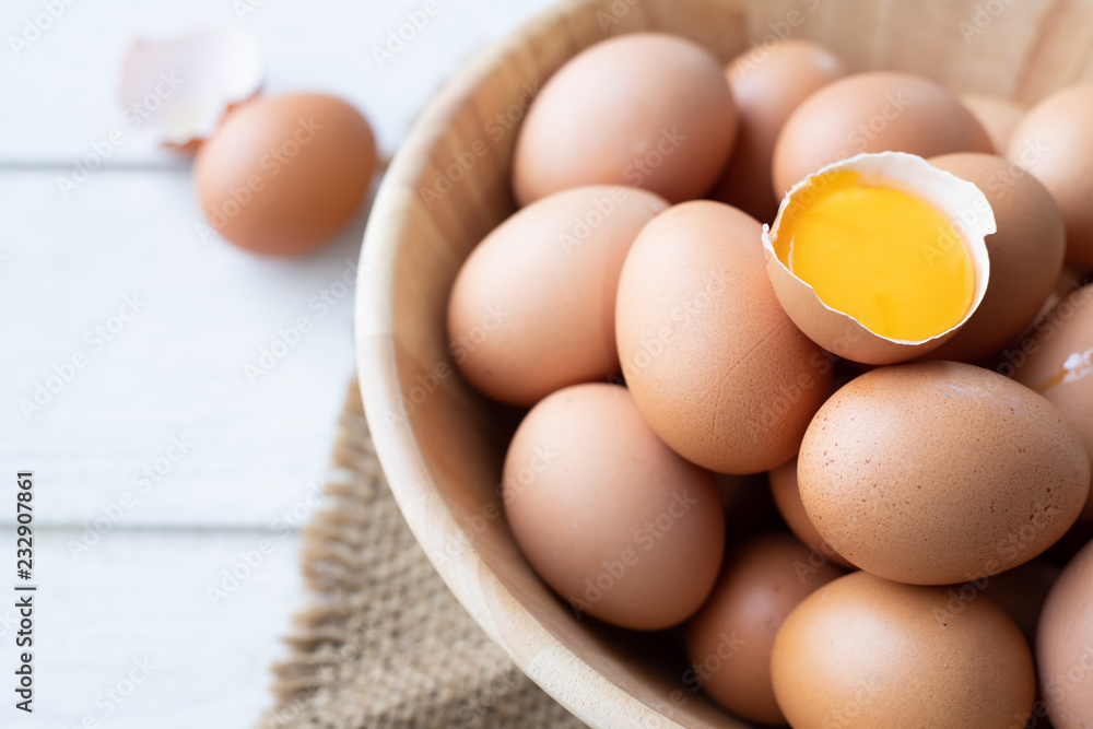 kitchen wood table with close up of egg in basket. kitchen wood table with close up of egg in basket.