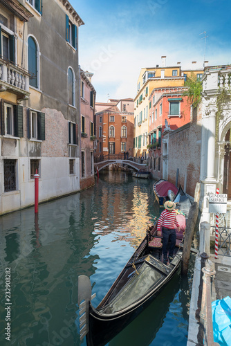 VENICE, ITALY- OCTOBER 30, 2018: Traditional narrow canal with gondolas in Venice, Italy © villorejo