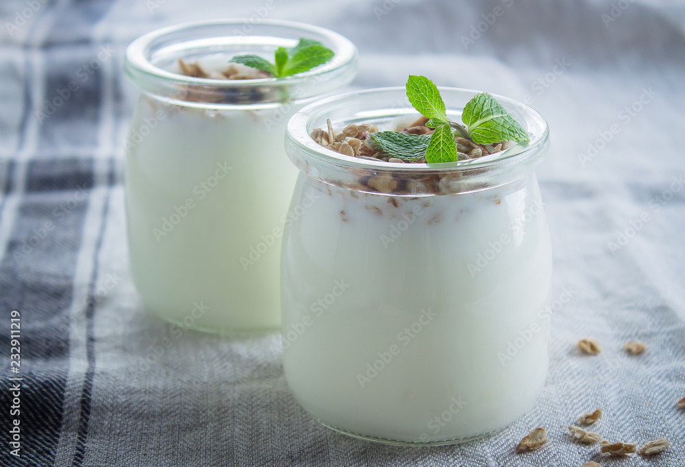 Homemade granola with greak yogurt in a glass jar. Healthy food concept. CLose-up Homemade granola with greak yogurt in a glass jar. Healthy food concept. CLose-up