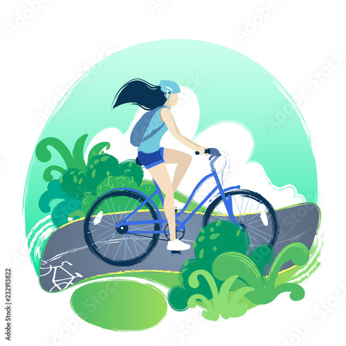 Teenage girl riding the bicycle on the bike path through the green fields.