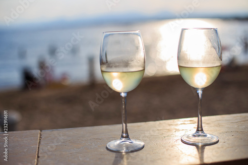 two glasses of white wine and the sea 