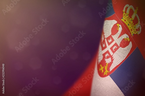 Serbia flag for honour of veterans day or memorial day. Glory to the Serbia heroes of war concept on purple dark velvet background.