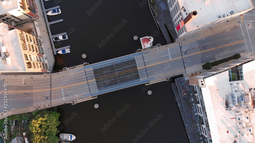 Milwaukee river in downtown, harbor districts of Milwaukee, Wisconsin, United States. Real estate, condos in downtown. Aerial view, drone flying Milwaukee river in downtown, harbor districts of Milwaukee, Wisconsin, United States. Real estate, condos in downtown. Aerial view, drone flying