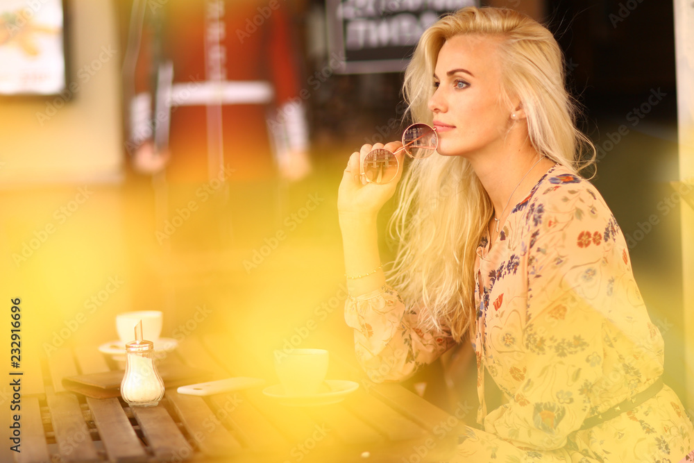 blond woman on lunch break sit in summer outdoor cafe with cup of coffee blond woman on lunch break sit in summer outdoor cafe with cup of coffee