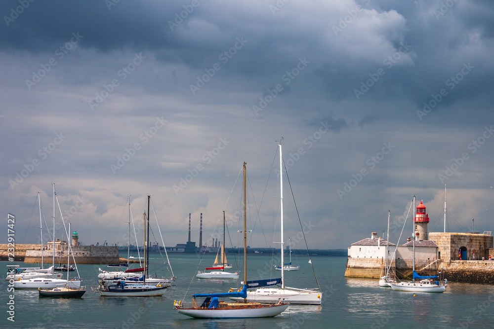 Sailing boats and lighthouse in harbour of Dun Laoghaire, county Dublin, Ireland