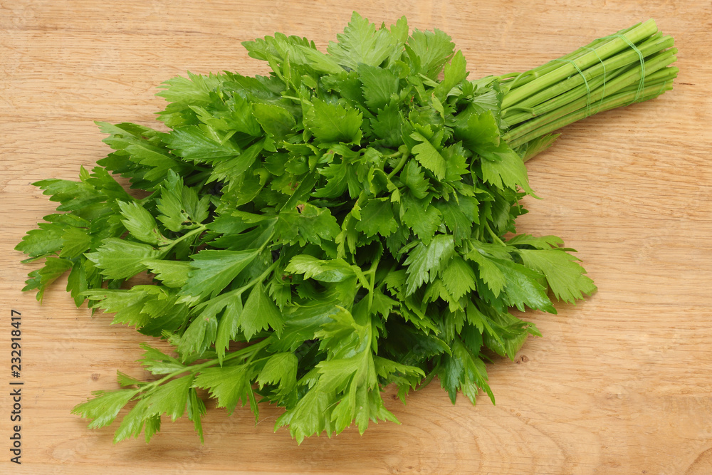 celery leaves on wooden table. Healthy food.