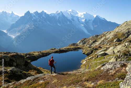 Hiker looking at Lac des Cheserys on the famour Tour du Mont Blanc near Chamonix, France.