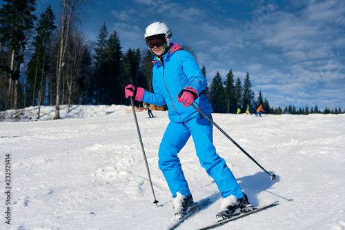 Young active sporty woman skiing at winter mountains