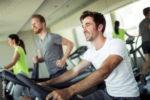Group of friends exercising on treadmill machine © NDABCREATIVITY