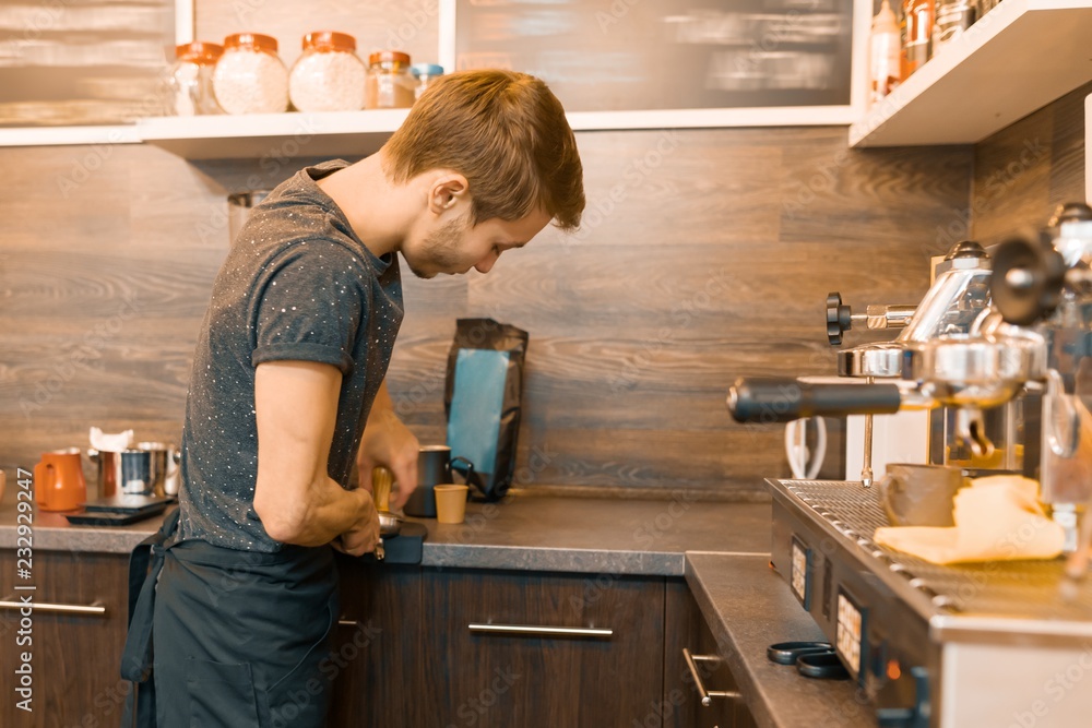 Portrait of young male barista making drinks. Coffee shop business concept - obrazy, fototapety, plakaty 
