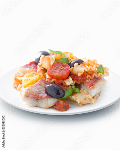 Grilled fish with vegetables on white plated, close-up