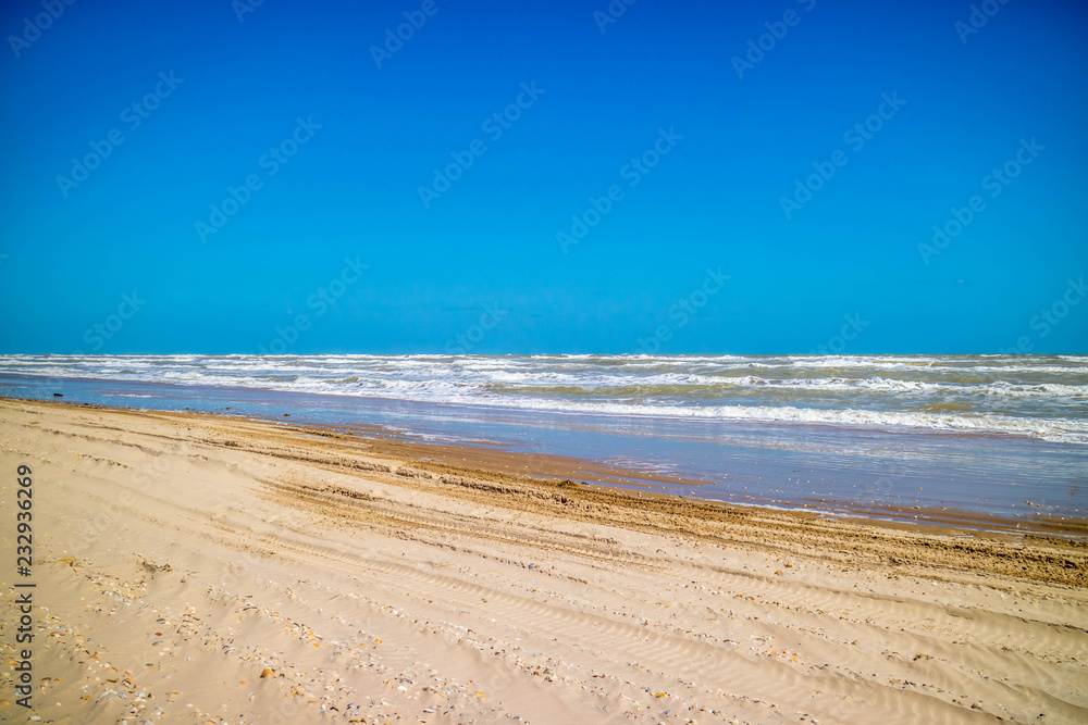 A beautiful soft and fine sandy beach along the gulf coast of Texas in South Padre Island, Texas