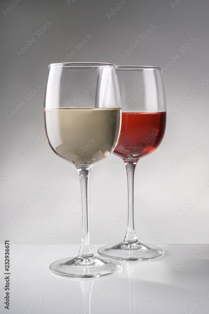 Glasses of expensive red and white wines on table Glasses of expensive red and white wines on table
