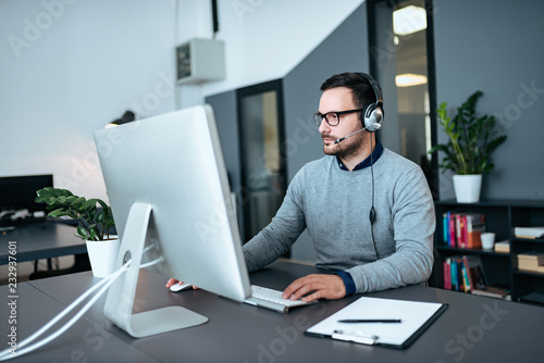 Tableau sur toile Handsome customer service representative at work.