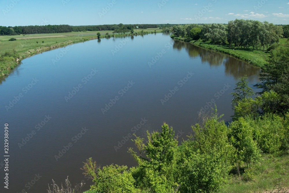 Bug River. Poland wschodnia.Dolina river with trees growing on the shore. Bug River. Poland wschodnia.Dolina river with trees growing on the shore.