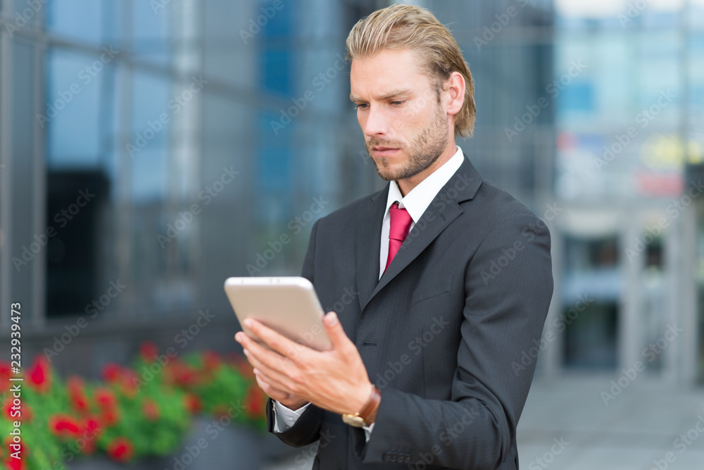 Businessman using a digital tablet in an urban environment Businessman using a digital tablet in an urban environment