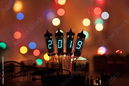 Happy new year is written with a lamp light. Radio electronic lamps. 2019. Original designed congratulation with a beautiful bokeh.