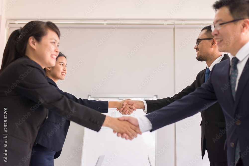 Business team asian people in formal suit shaking hands finishing up meeting,Selective focus,Happy partnership Business team asian people in formal suit shaking hands finishing up meeting,Selective focus,Happy partnership