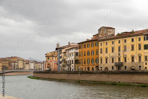PISA, ITALY - OCTOBER 29, 2018: View of the medieval town of Pisa from bridge "Ponte di Mezzo" on river Arno © villorejo
