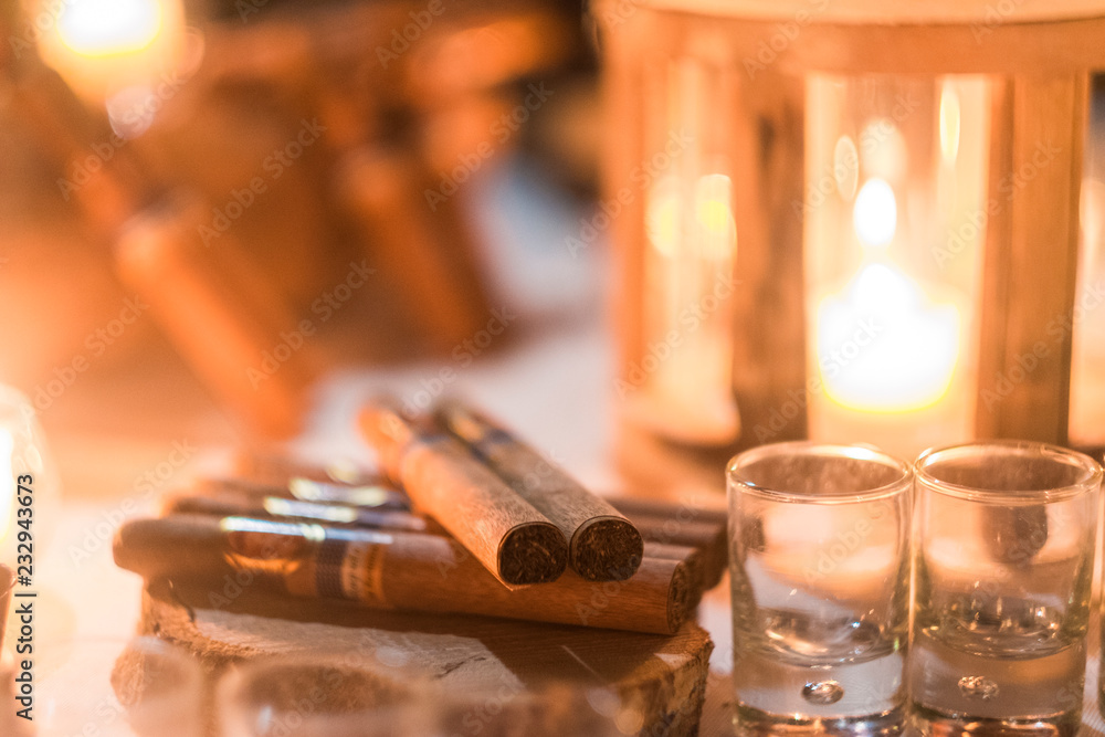 Cigar and rhum rum to end the night in friednship with men's things related. Bokeh and defocused image for conceptual mood about males