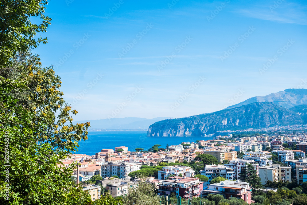 Above view of Sorrento Naples Campania Italy holiday beautiful city place. Mediterranean scenic place with blue sea and high cliffs mountains. Naples and Vesuvio in background