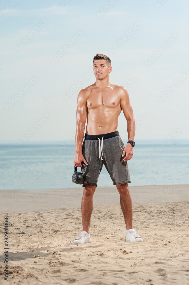 Athletic hot handsome man short haircut brunet with naked body holding ...