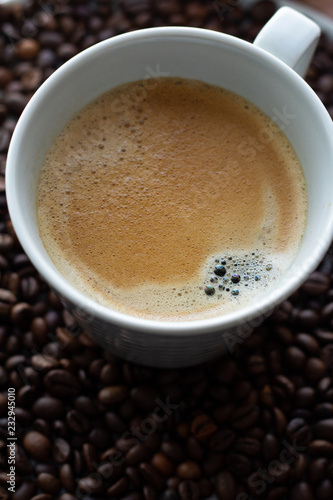 cup of americano coffee on coffee beans. © ytochka89