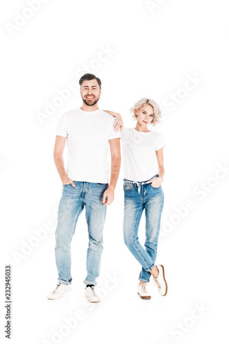 Wonderful smiling couple standing together while woman leaning to man isolated on white