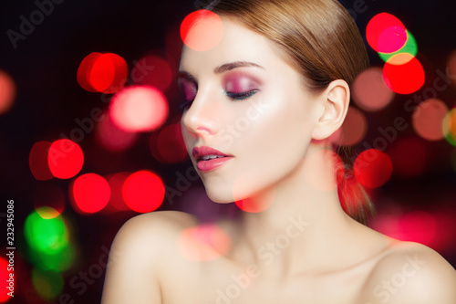 Perfect female face on sparkle bokeh background