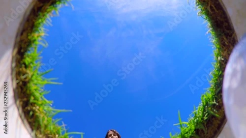 Wallpaper Mural Directly Below View on a Golfer Putting the Golf Ball in the Golf Hole and Golfer Picking Up the Ball from the Hole in a Sunny Day with Blue Sky. Torontodigital.ca