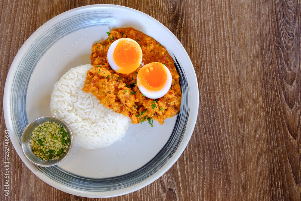 Rice served with fried Hepatopancreas shrimps and have boiled fever on top. The sauce is made from chili as a side dish. This is a typical Thai food. Rice served with fried Hepatopancreas shrimps and have boiled fever on top. The sauce is made from chili as a side dish. This is a typical Thai food.