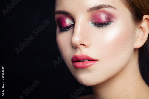 Glamorous woman with pink eyeshadow makeup on black