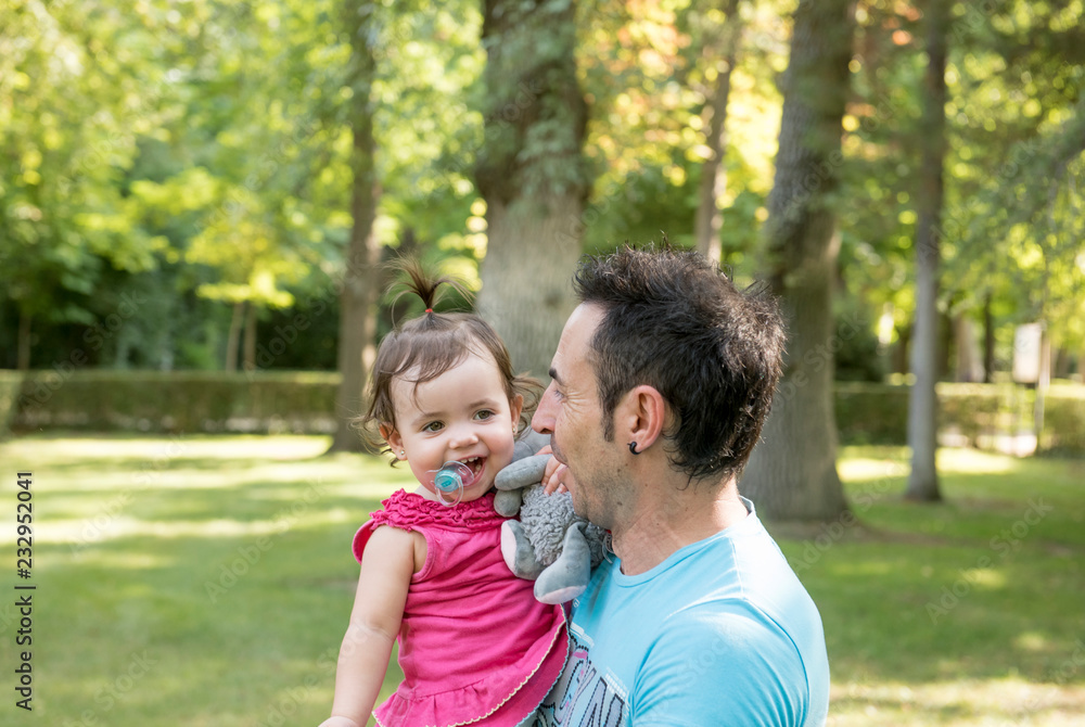 Beautiful baby in the park with her father