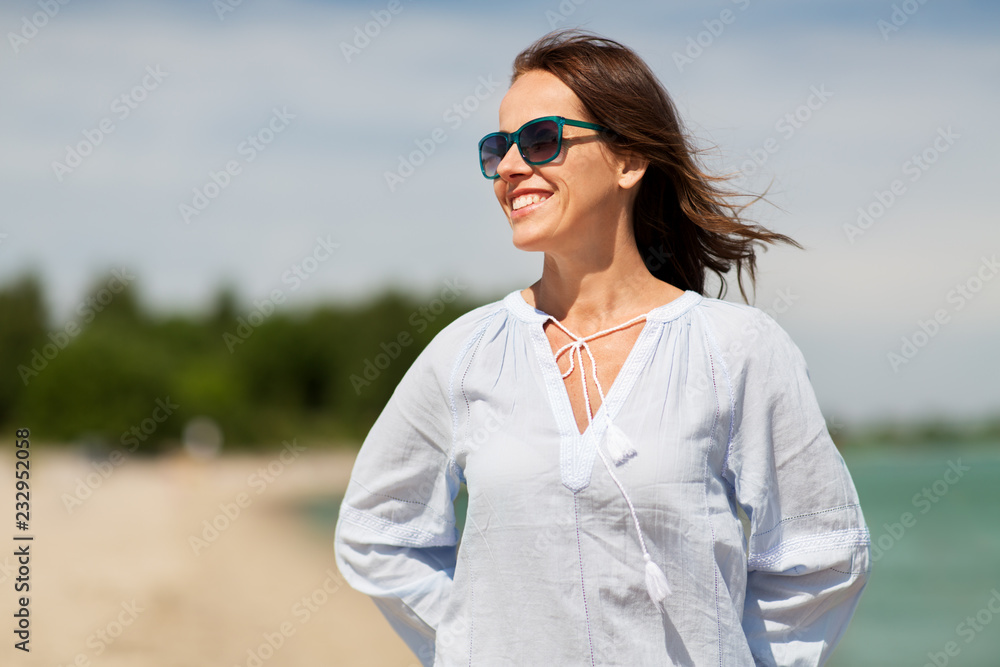 people and leisure concept - happy smiling woman in sunglasses on summer beach people and leisure concept - happy smiling woman in sunglasses on summer beach