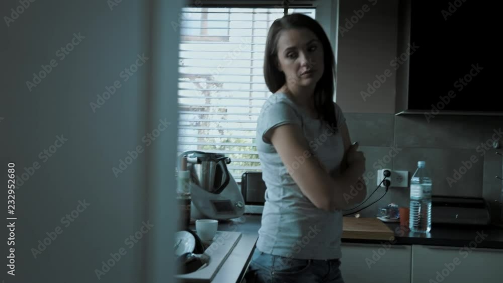 Upset, miserable woman suffering in the kitchen Upset, miserable woman suffering in the kitchen