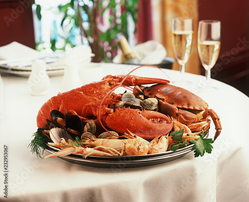 Seafood platter, lobster, shrimp, crab, restaurant setting.