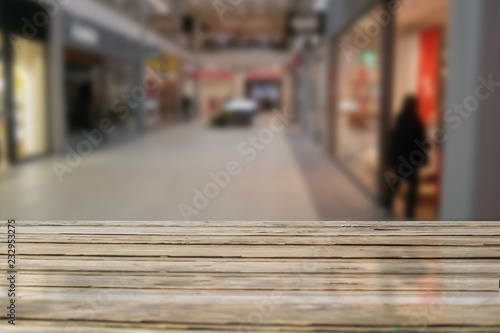 Wood table with blured market background and people. Copy space for display product