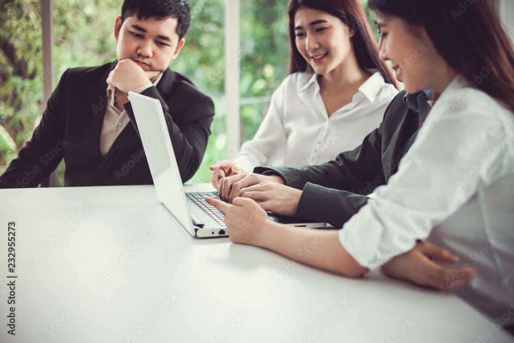 Businesspeople working on the laptop while meeting in the meeting room at the office. Businesspeople working on the laptop while meeting in the meeting room at the office.