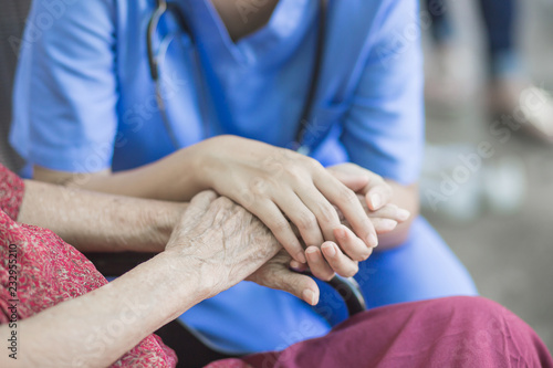 Asian eldery  woman with her caregiver at home. Home care or Elderly care concept.