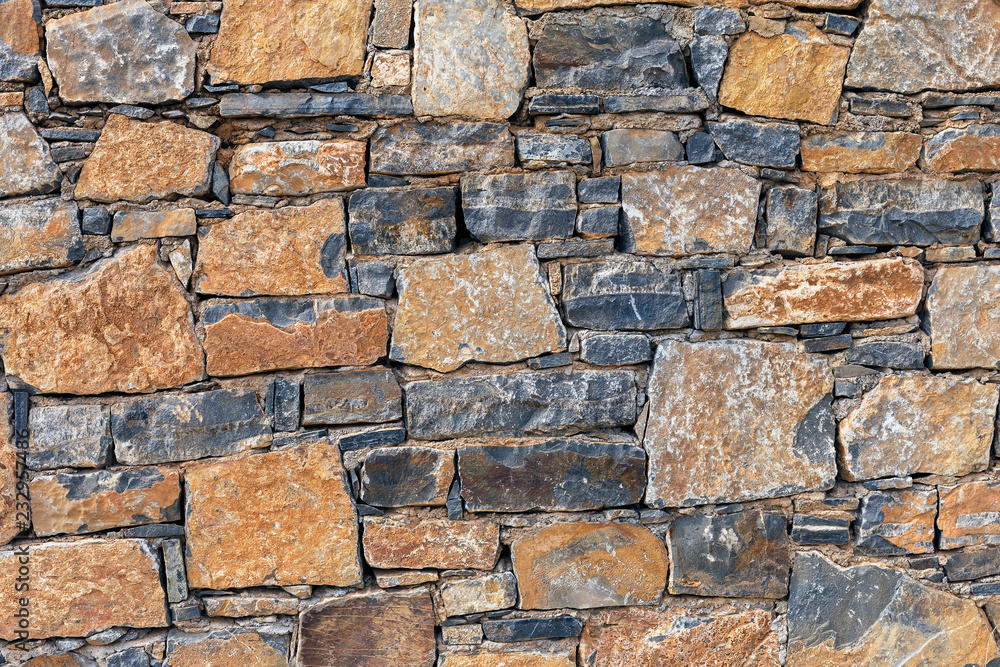 beautiful stone wall of stones of different colors close up, horizontal beautiful stone wall of stones of different colors close up, horizontal